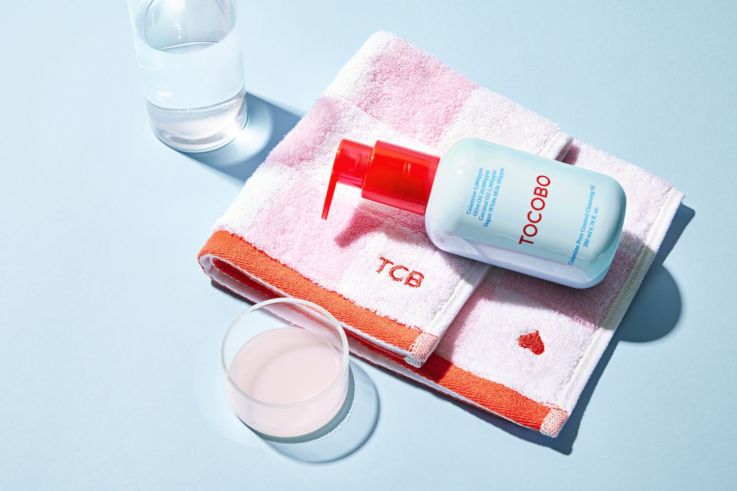 Cleansing oil bottle standing on bathroom shelf