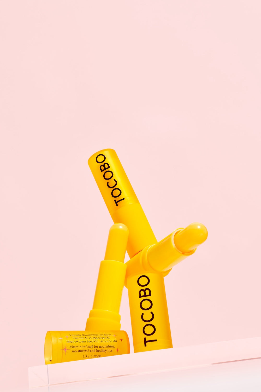Tocobo Vitamin Nourishing Lip Balm held between fingers