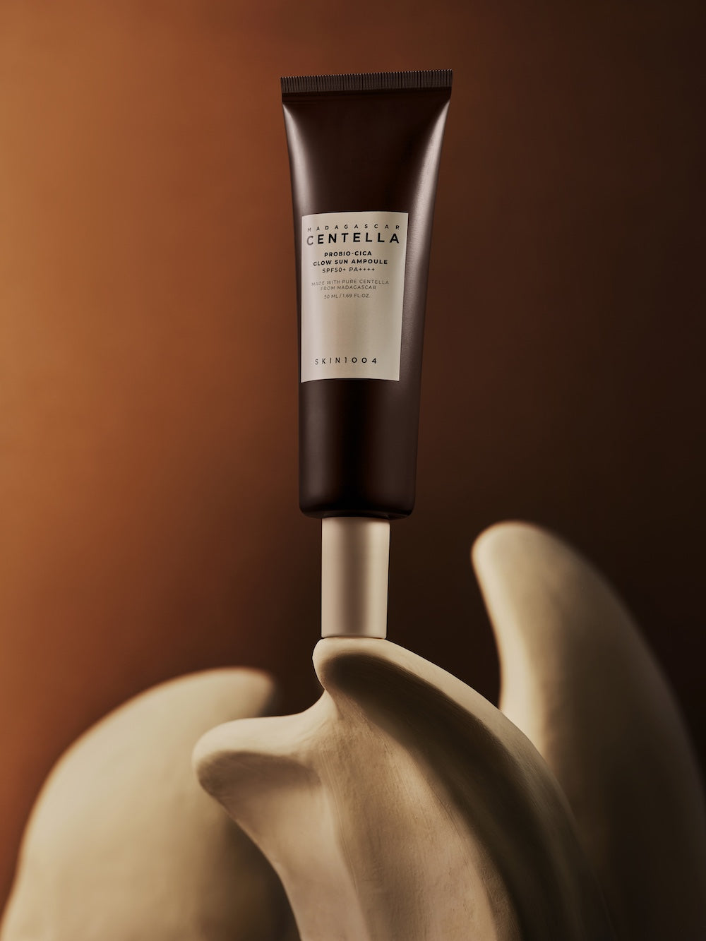 A thin, dewy layer of sun serum on bare skin