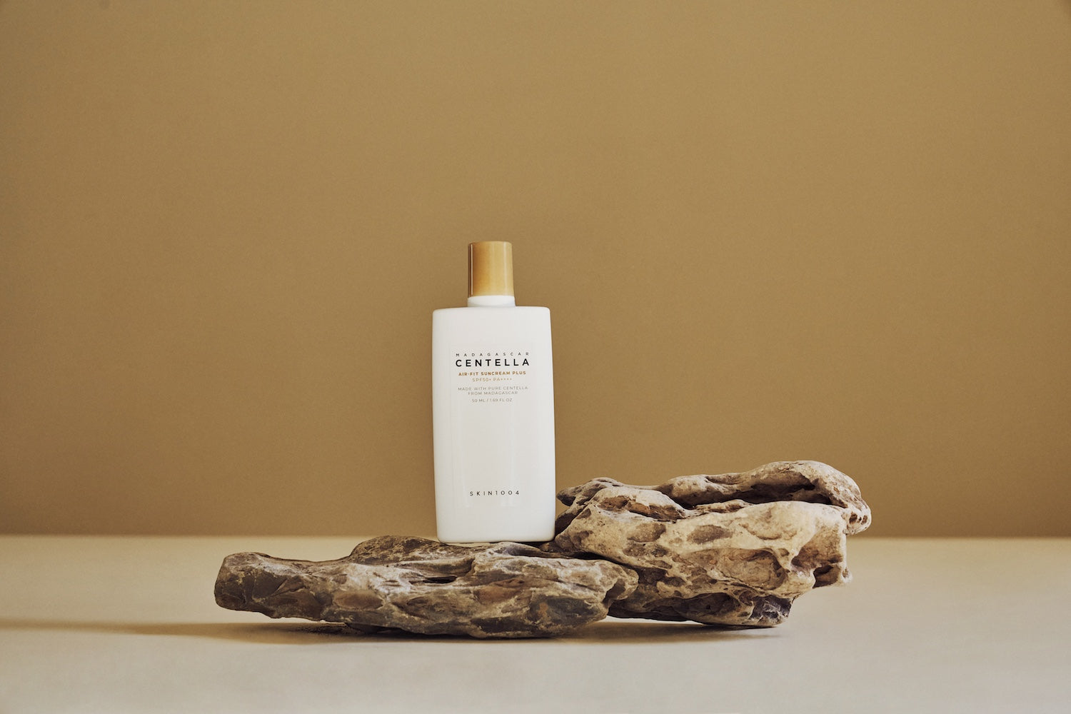 Suncream bottle shown from a slight overhead angle