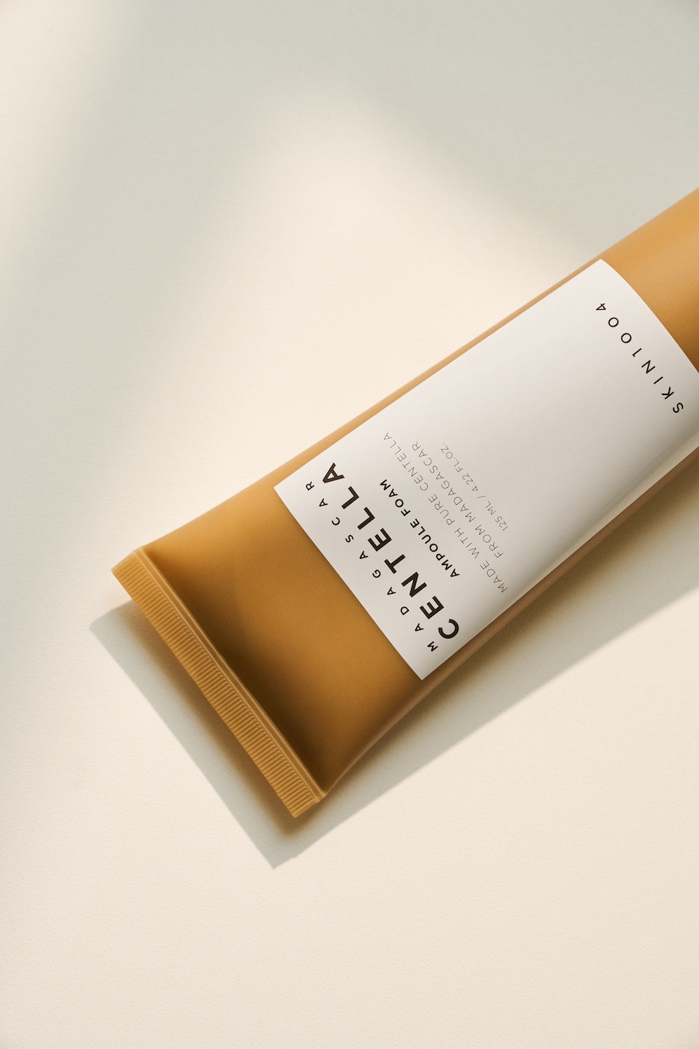 The cleanser tube standing beside a cleansing oil bottle