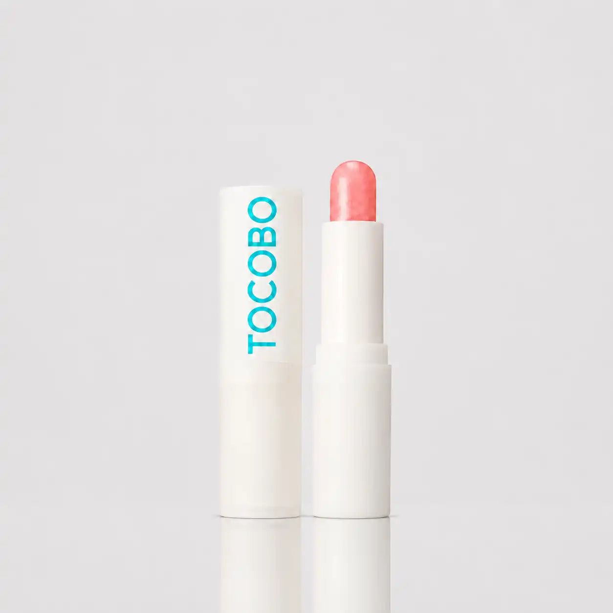 TOCOBO glow ritual lip balm coral water front view
