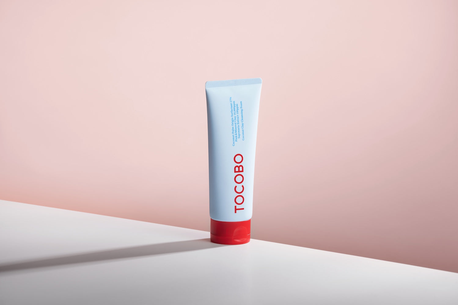Cleansing foam tube standing on bathroom shelf