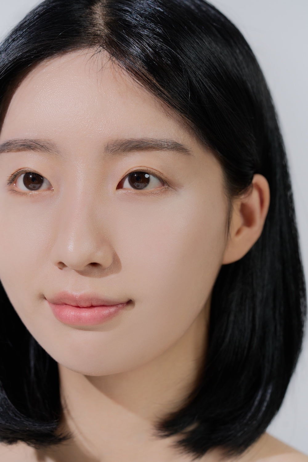 A thin, dewy layer of sun serum on bare skin