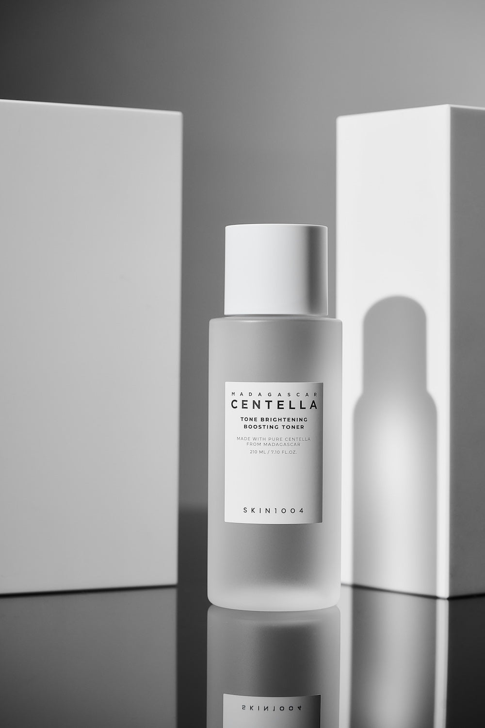 Toner bottle next to tone brightening ampoule