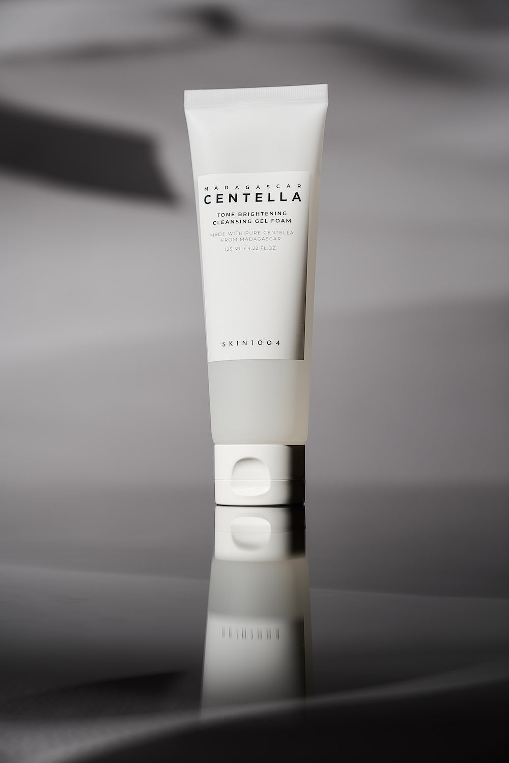 Cleanser tube standing on bathroom shelf