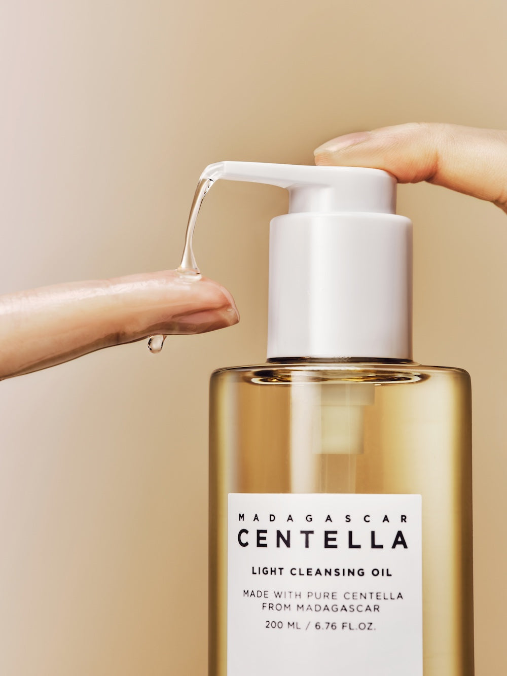 Cleansing oil dispensed onto dry fingertips