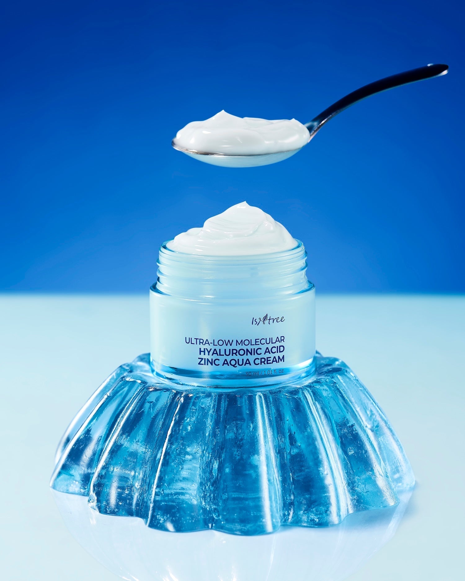 Aqua cream texture stretched between fingers
