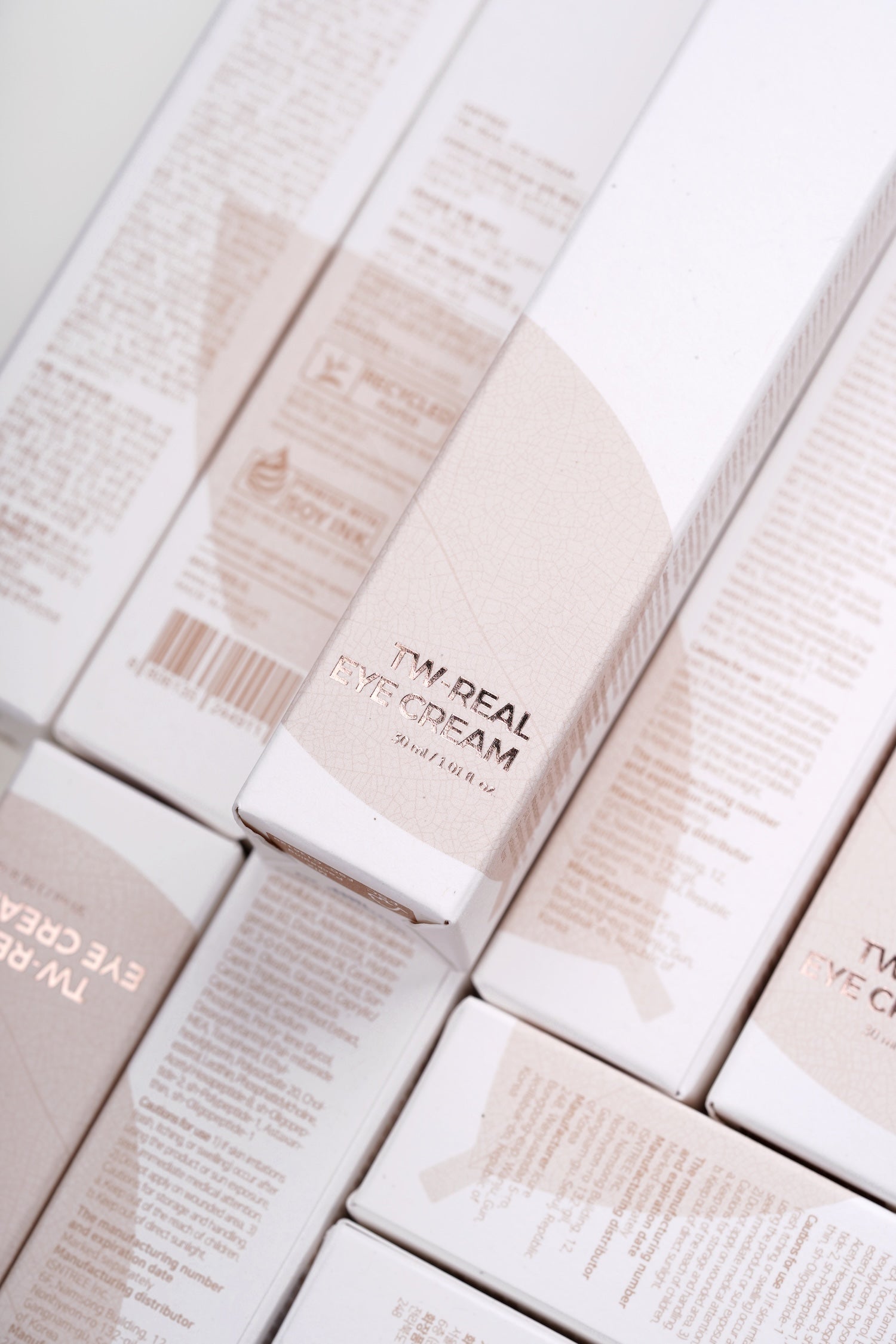 Model tapping eye cream gently into under eye area