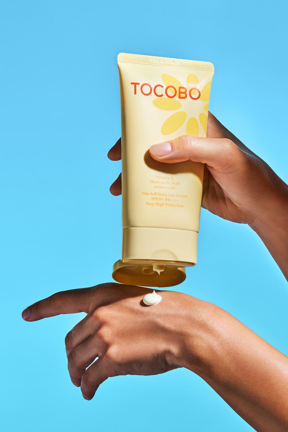 Sun lotion pump dispensing onto palm