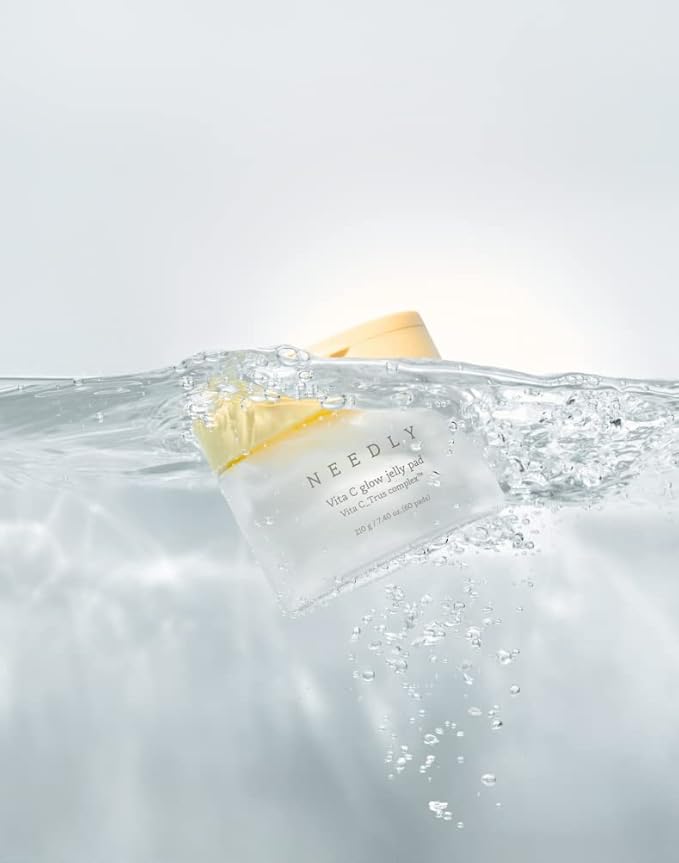 Needly Vita C Glow Jelly Pad submerged in water showing hydrating, vitamin-rich formula and refreshing texture